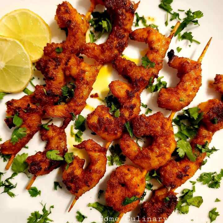This is the recipe of barbecued prawns with skewers. I had used wooden skewers here and grilled the prawns in oven. The difficulty level of this recipe is “easy”. A beginner can easily go ahead with this recipe. The main part lies in the preparation of marinade. The prawns are cleaned and marinated with the prepared marinade for over 1 hour. This makes the prawns more juicier after grilling.