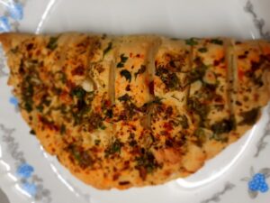 This recipe helps you to prepare a soft and fluffy garlic bread which is flavored with garlic and mixed herbs and filled completely with cheese. Cheese Garlic Bread can be easily prepared with minimum ingredients at your home. The recipe is too simple.